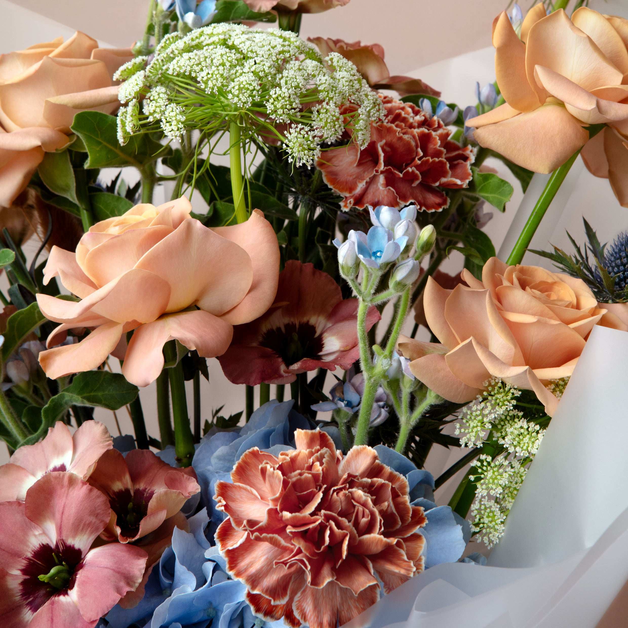 Bouquet of colorful flowers with a white tissue paper
