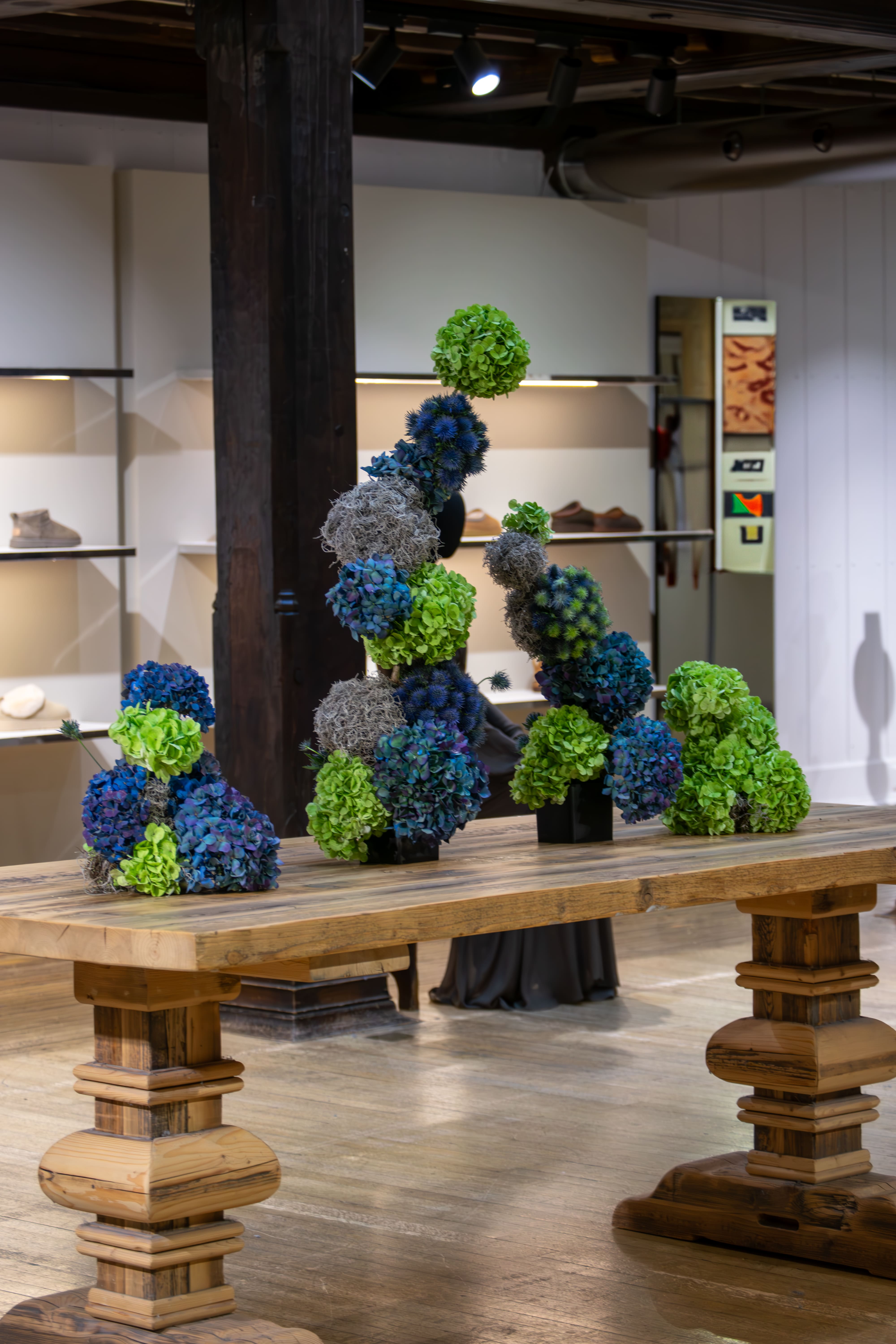 Decorative floral arrangements on a wooden table in an indoor setting
