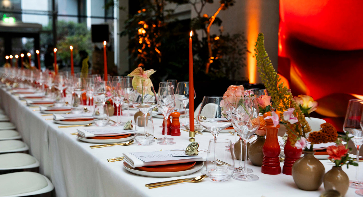 Decorated table with candles and floral arrangements in a formal setting